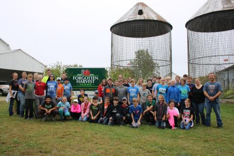 Seventh and eighth grade students weeded squash fields and picked more 15,000 ears of corn in three hours at Forgotten Harvest Farm in Fenton.